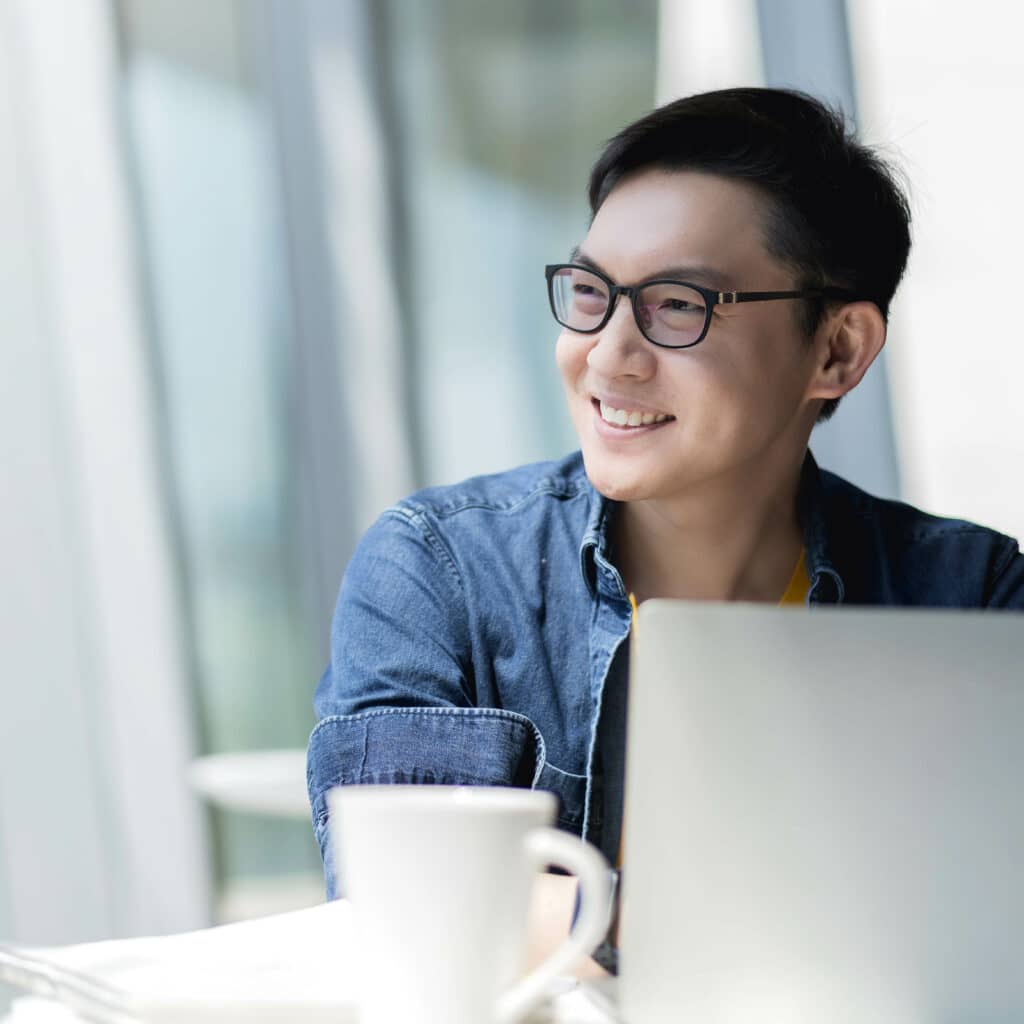 Smart attractive positive asian business male wearing glasses wo