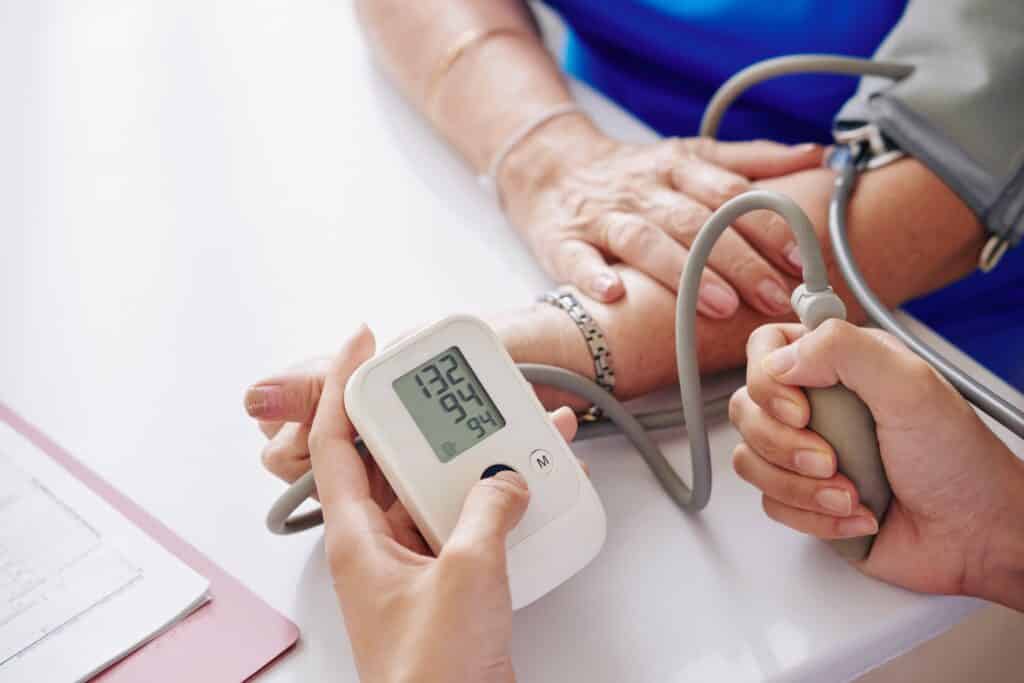 Measuring blood pressure of elderly woman