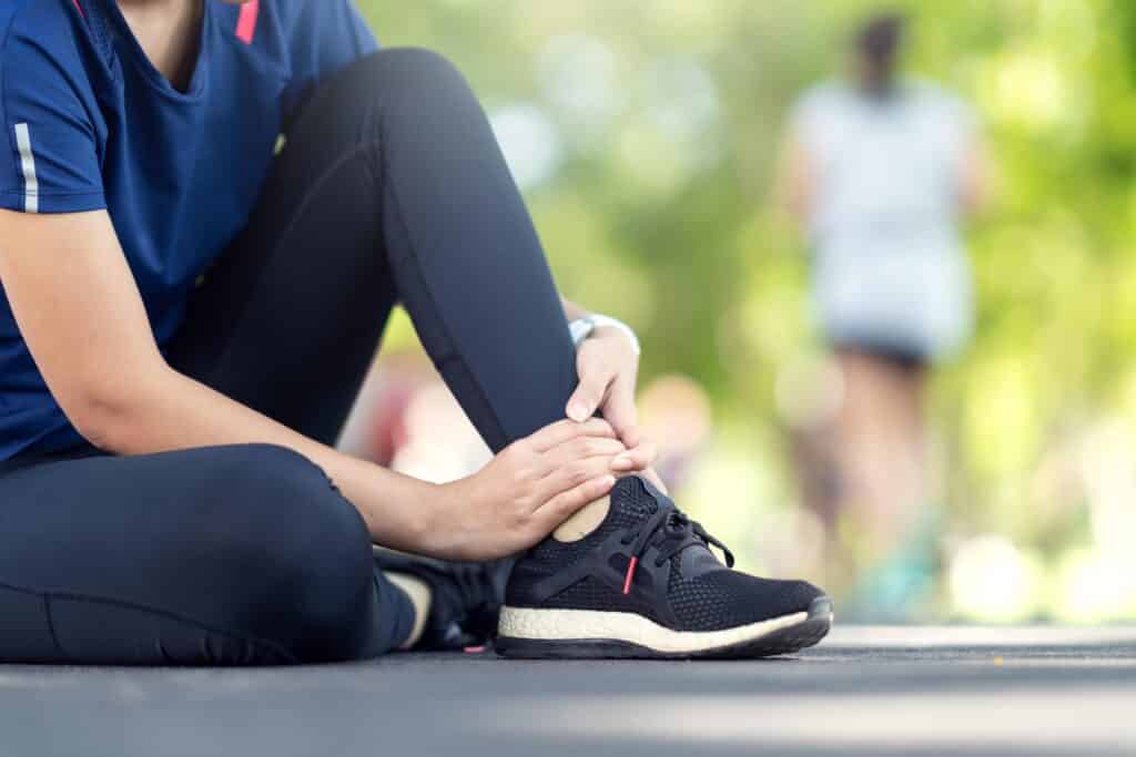 Young asian woman suffering ankle injury