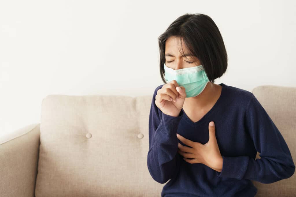 Asian girl symptom cough and are protective with medical mask wh